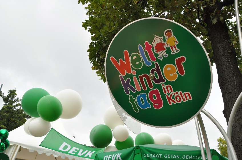 Pressemitteilung Weltkindertag - Luftballons und Logo Weltkindertag am DEVK-Stand